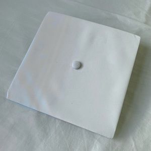 White graduation cap and gown